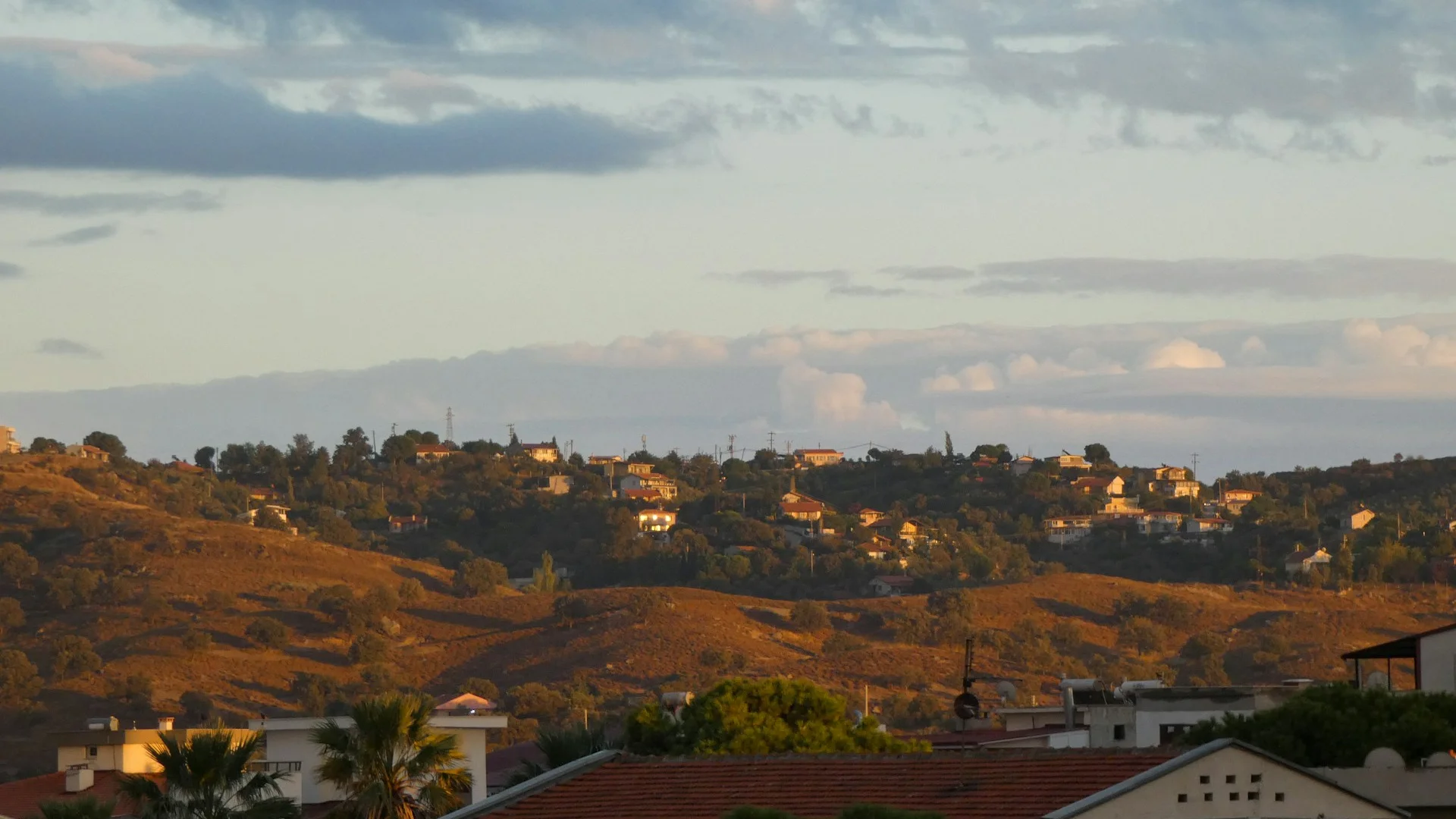Signal Hill ridge with Battalion Park visible and Rocky Mountains in the background at dusk
