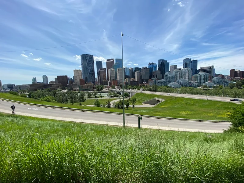 Battalion Park hillside trail with regimental numbers visible on the escarpment slope, Signal Hill Calgary