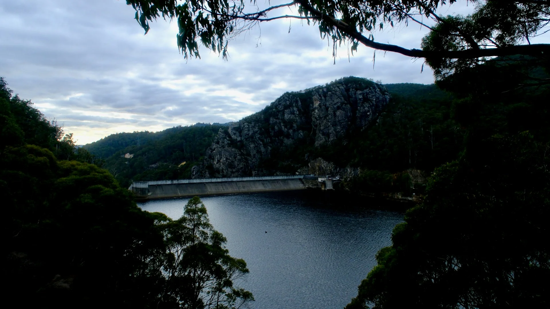 Battalion Park hillside with battalion numerals carved into the escarpment, Rockies visible in the distance at dusk