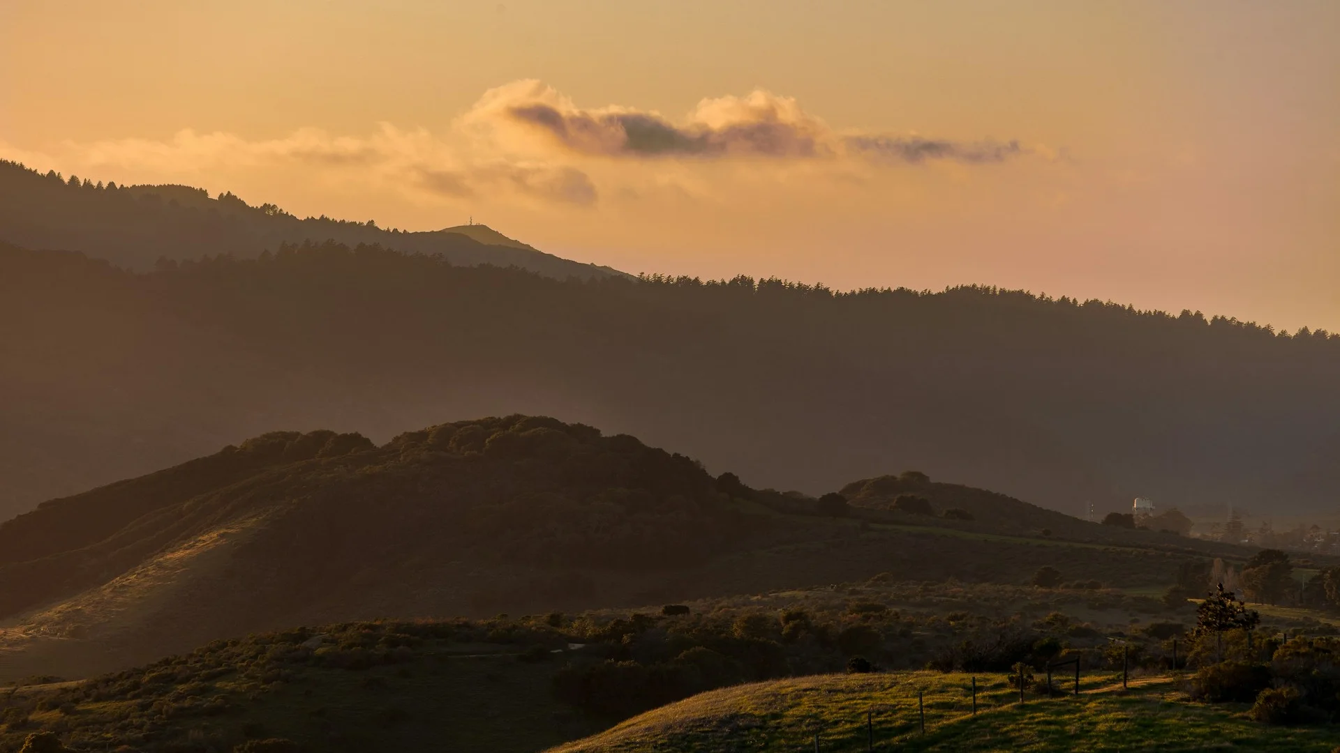 Signal Hill ridge at dusk with Rocky Mountains visible in the background