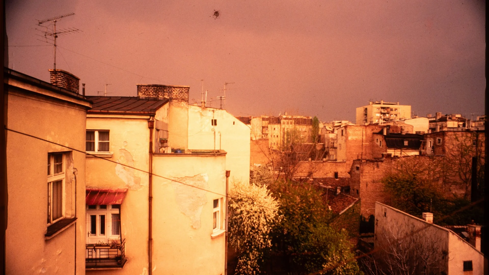 Signal Hill rooftops with dark storm clouds building over the Rocky Mountain foothills to the west