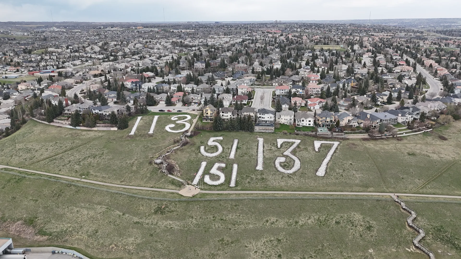Aerial drone view of the Battalion Park numerals looking north over Signal Hill Calgary homes and community