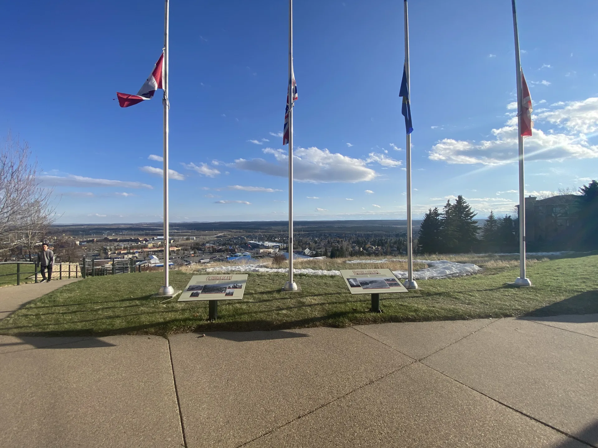 Battalion Park memorial flagpoles overlooking Signal Hill neighbourhood in Calgary with panoramic views